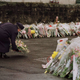 Queen Elizabeth places a floral bouquet in front of Dunblane Primary School March 17, 1996.